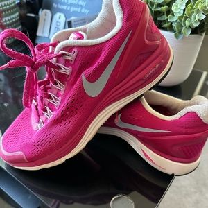 Women’s pink and white Nikes